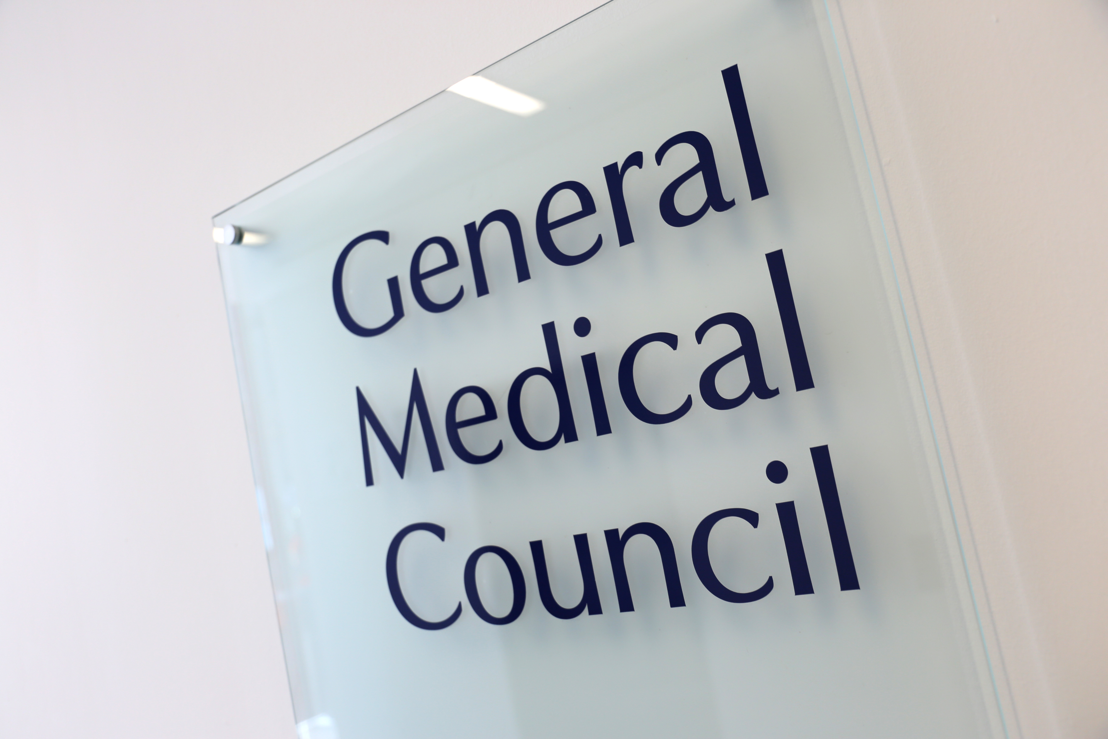 A GMC name plaque, bolted to the wall in the reception at the GMC