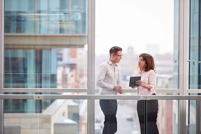 Two colleagues in conversation using an ipad
