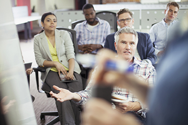 A group of attendees feeding back to a group facilitator.