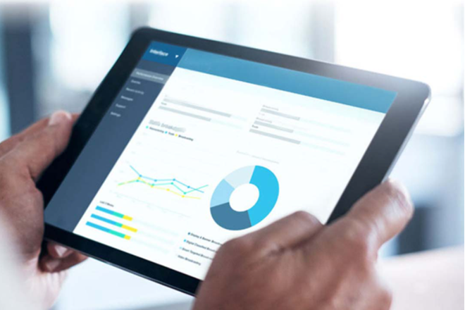 Close up of someone using a tablet device analysing data charts
