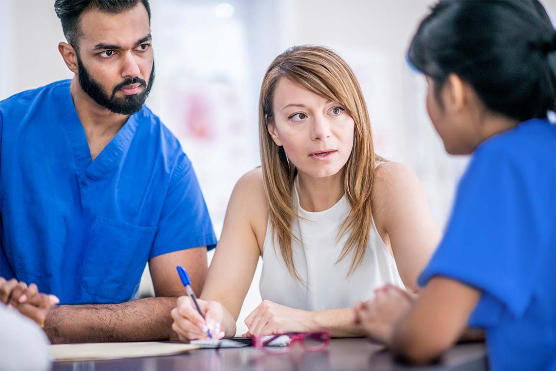 Medical professionals in conversation in a healthcare setting