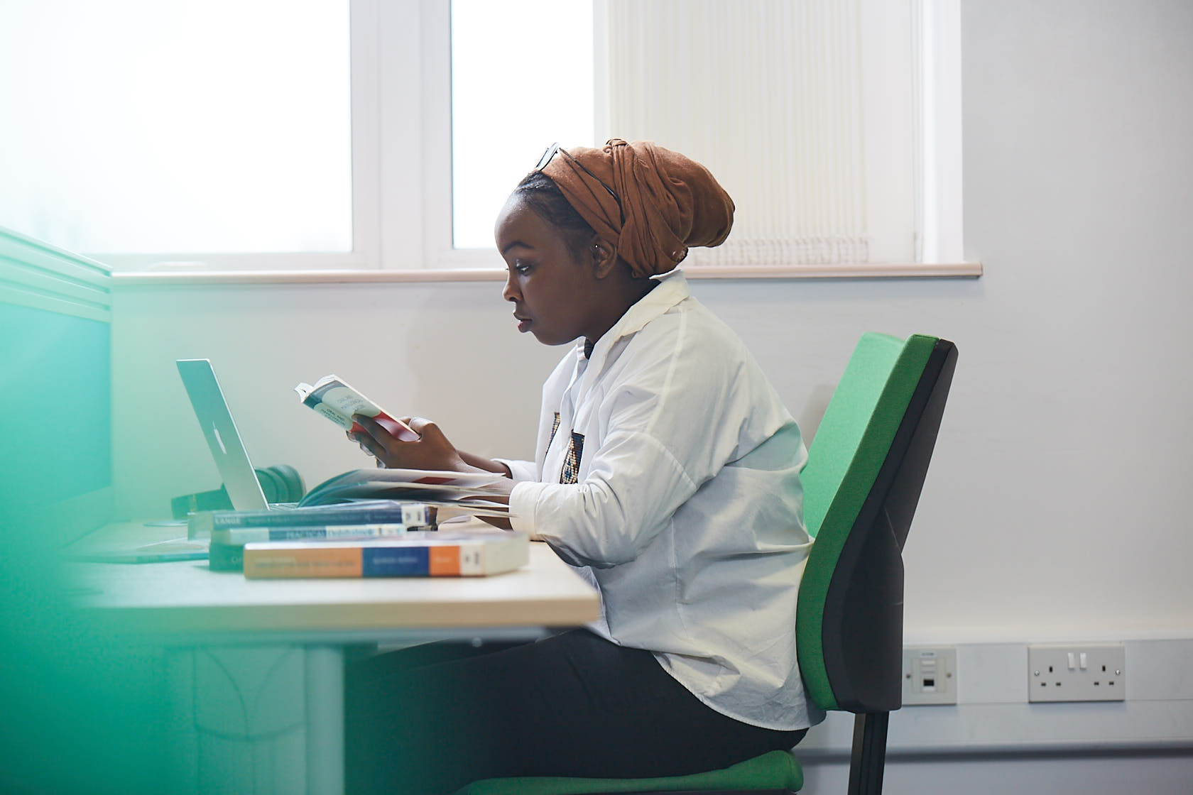 A medical student studying at a laptop