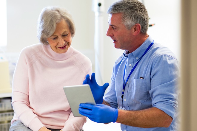 A doctor discussing notes with a patient