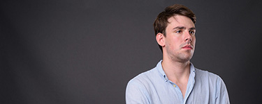 A man in a light blue button-up shirt
