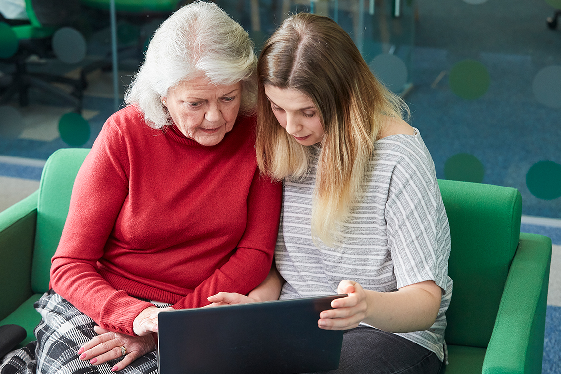 Grandmother and grandchild using a laptop