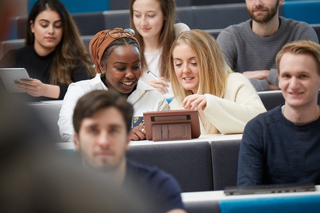 Students sitting together in a lecture theatre