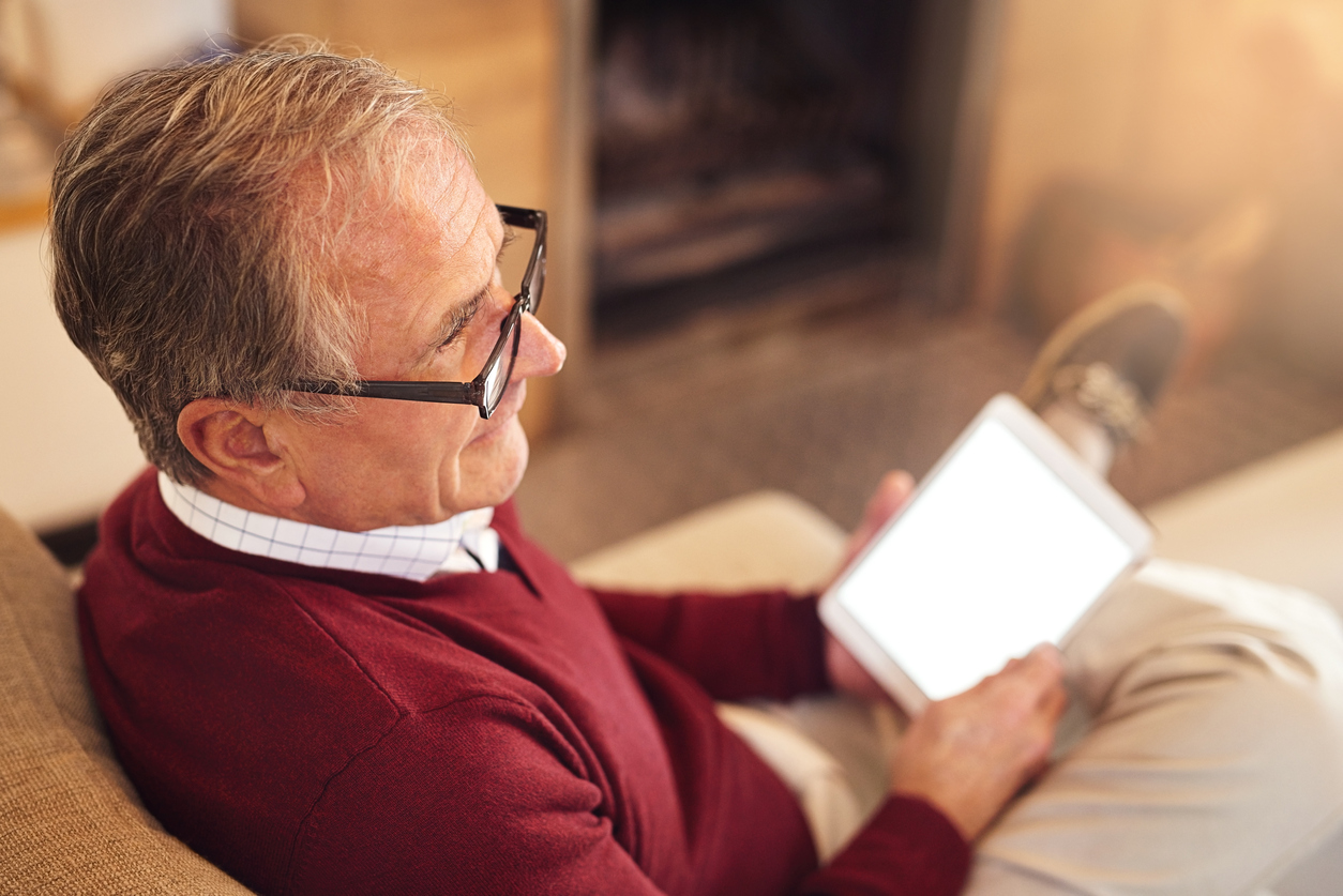 A man sat using an IPad