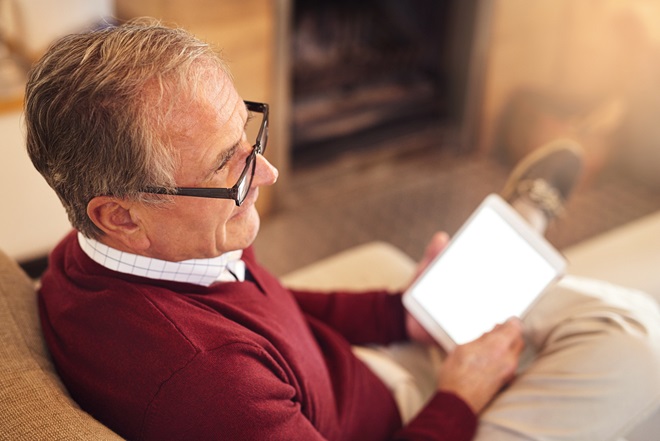 A man sat using an IPad