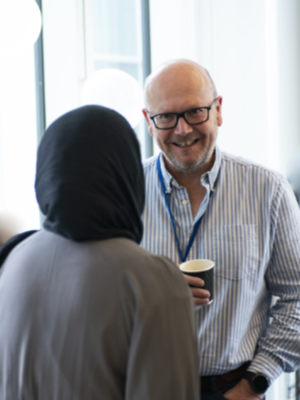 Two members of staff chat informally