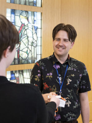 A member of the reception team greats a visitor