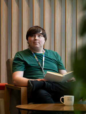A member of staff reading a book during a break