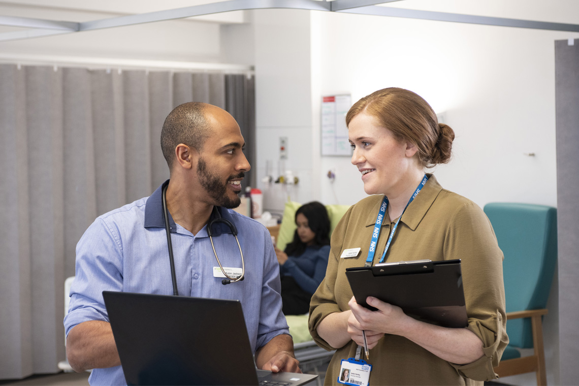 A doctor and physician associate in discussion