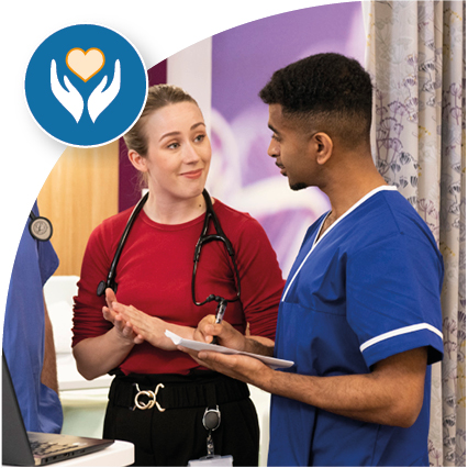 Two medical professionals stood in conversation. 